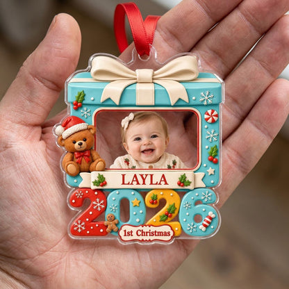 Light blue gift-box photo ornament with cream bow, teddy bear, red trim, and colorful 2026 base with 1st Christmas.