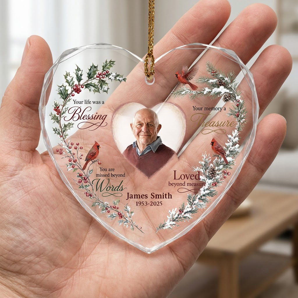 Heart glass ornament with a photo, red cardinals, and a winter wreath of pine, holly, berries, and pinecones.