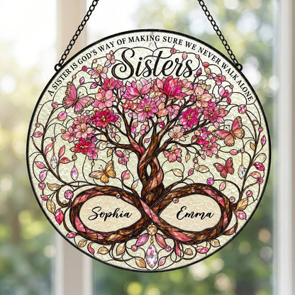 Round stained glass suncatcher with tree of life, pink blossoms, butterflies, and Sisters text with two names.