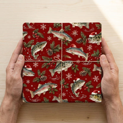 Red Christmas wrapping paper with largemouth bass and rainbow trout, some in Santa hats, pine branches, pinecones, berri
