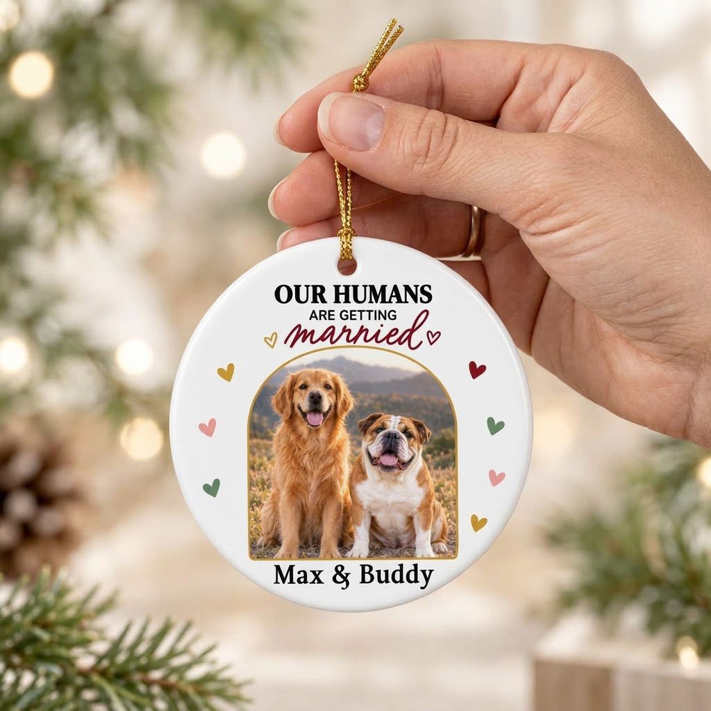 Round ceramic ornament with arch dog photo, “OUR HUMANS ARE GETTING married” text, and colorful heart accents.