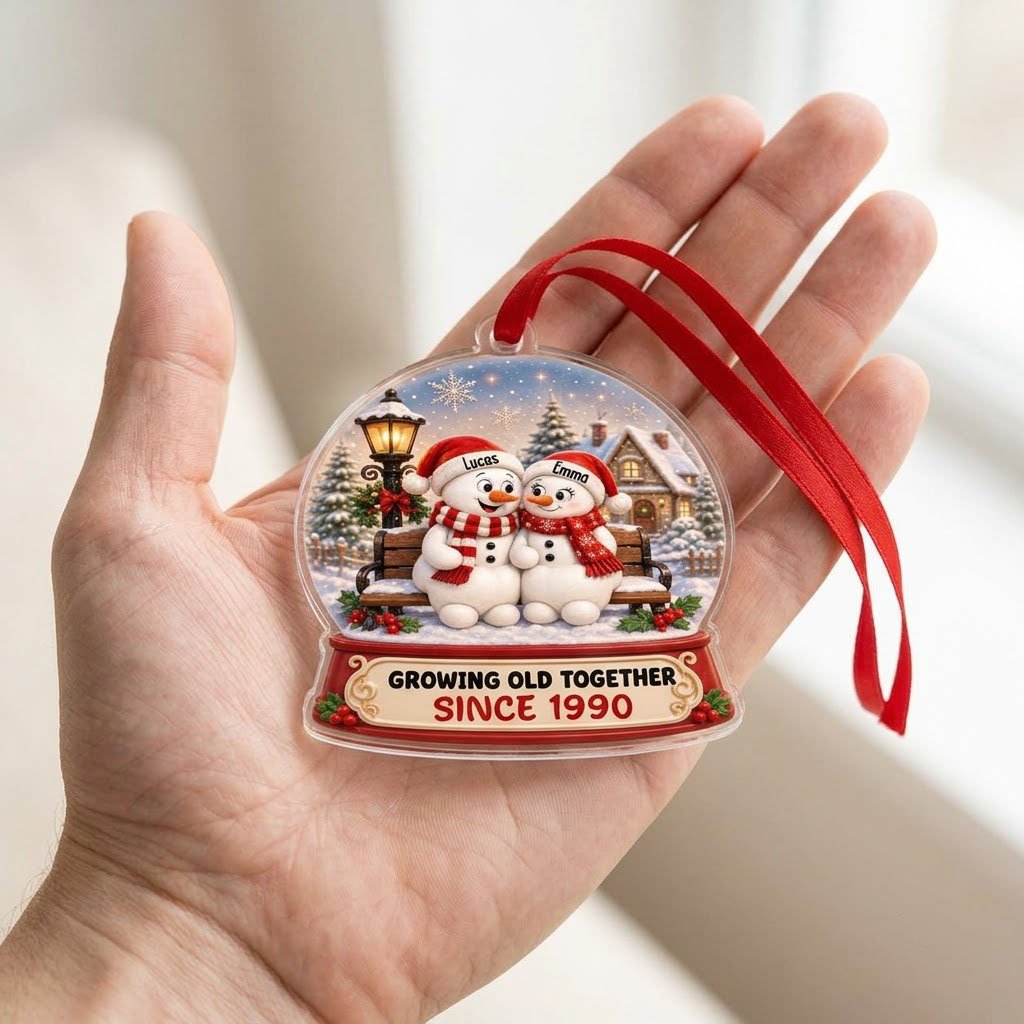 Acrylic snowglobe ornament with two snowmen on a bench, Santa hats, and Growing Old Together text.