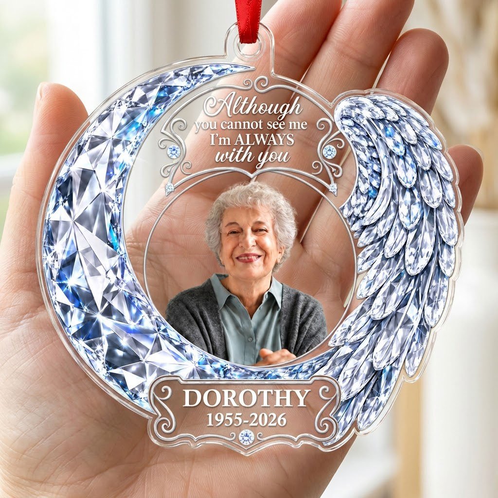 Acrylic ornament with blue crystal-look crescent moon, angel wing, circular photo frame and memorial quote.
