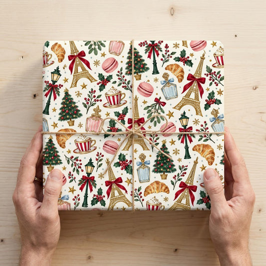 Cream paper with gold Eiffel Towers, Christmas trees, street lamps, macarons, croissants, holly and stars pattern.