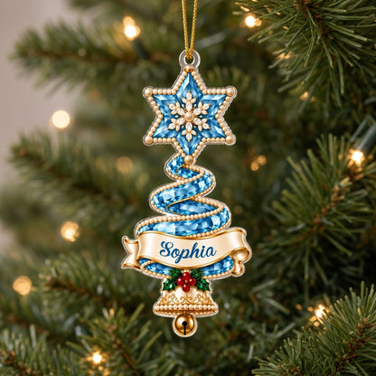 Custom-cut acrylic ornament of a jeweled ribbon Christmas tree with star topper, holly sprig, name banner, and a gold be