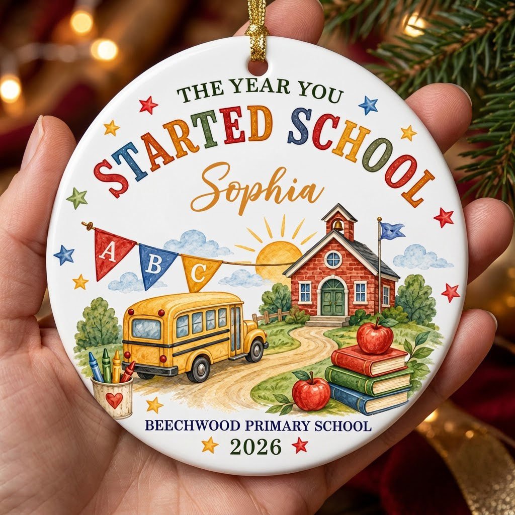 Round ceramic ornament with watercolor school bus, red brick schoolhouse, ABC bunting, books, apples, and colorful stars