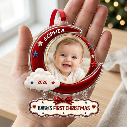 Red crescent moon acrylic ornament with baby photo, cloud, stars, and a plaque reading Baby's First Christmas.