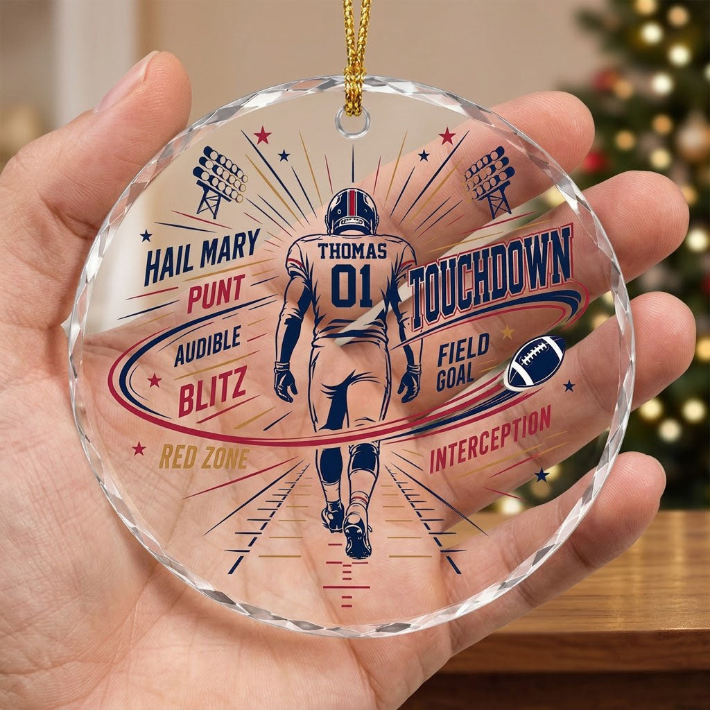 Round faceted glass ornament with football player back view, stadium lights, navy swoosh, and name and number.