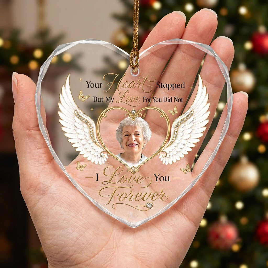 Heart-shaped glass ornament with white angel wings, gold heart photo frame, golden butterflies and sparkles.