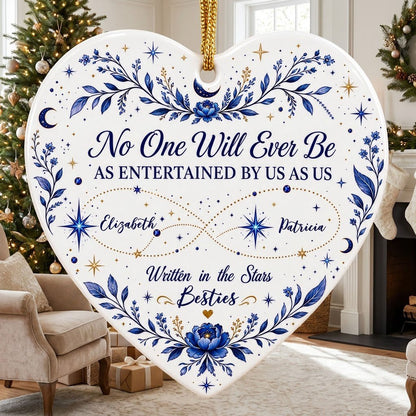 White heart ceramic ornament with blue florals, moons, stars, and “Written in the Stars Besties” with two names.