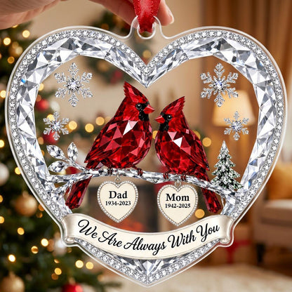 Heart ornament with two red crystal-style cardinals, snowflakes, a ribbon banner, and two dangling name-date heart charm