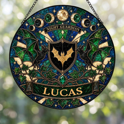 Round stained-glass suncatcher with gold bat shield, two black bats, moon phases, emerald gem, ivy and starbursts.