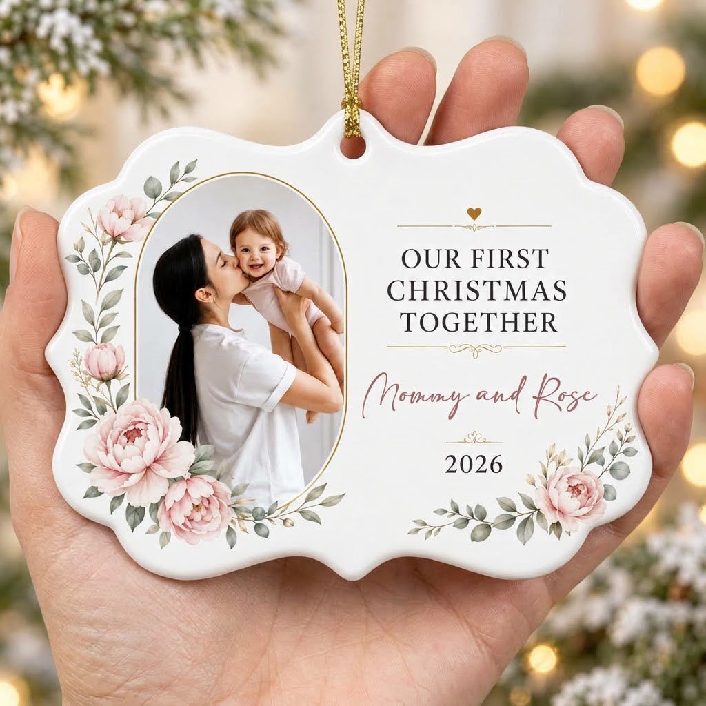 White scalloped ceramic ornament with gold oval photo frame, pink peonies, and Our First Christmas Together text.