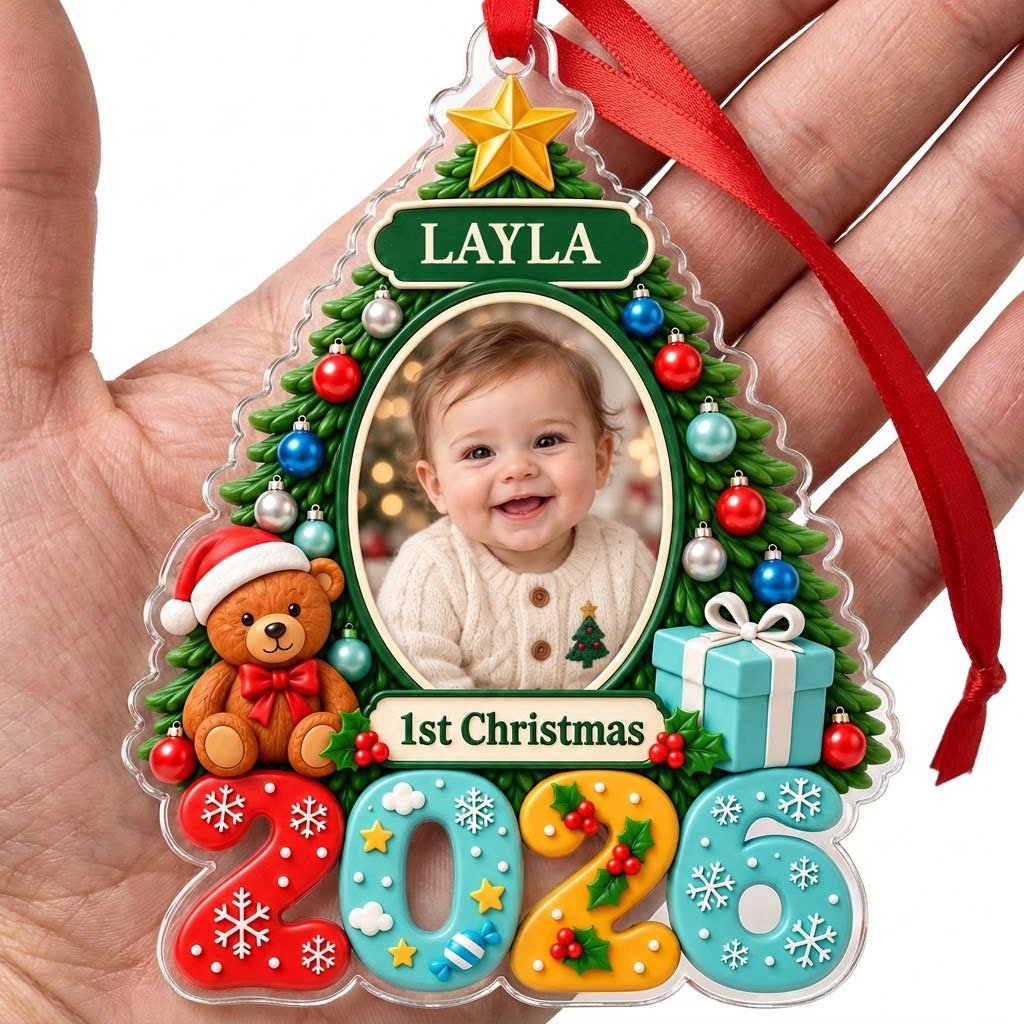Green Christmas tree acrylic ornament with star topper, baby photo frame, teddy bear, and 2026 numbers.