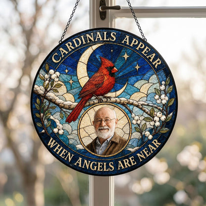 Round stained-glass style suncatcher with a red cardinal, starry blue sky, crescent moon, and a circular frame with a pe