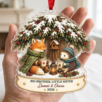 Acrylic ornament with snowy tree, fox and hedgehog holding mugs, banner says BIG BROTHER, LITTLE SISTER.