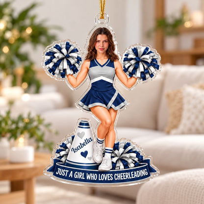 Custom acrylic cheerleader ornament with photo face, pom-poms, megaphone and name banner with red hanging ribbon.