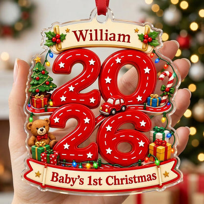 Custom-cut acrylic ornament with 'Baby's 1st Christmas', road-style 2026, holly banners, teddy bear and toy car.