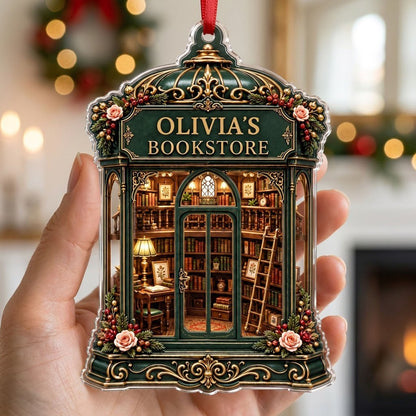 Green and gold ornate acrylic ornament with roses and a cozy bookstore interior reading OLIVIA'S BOOKSTORE.