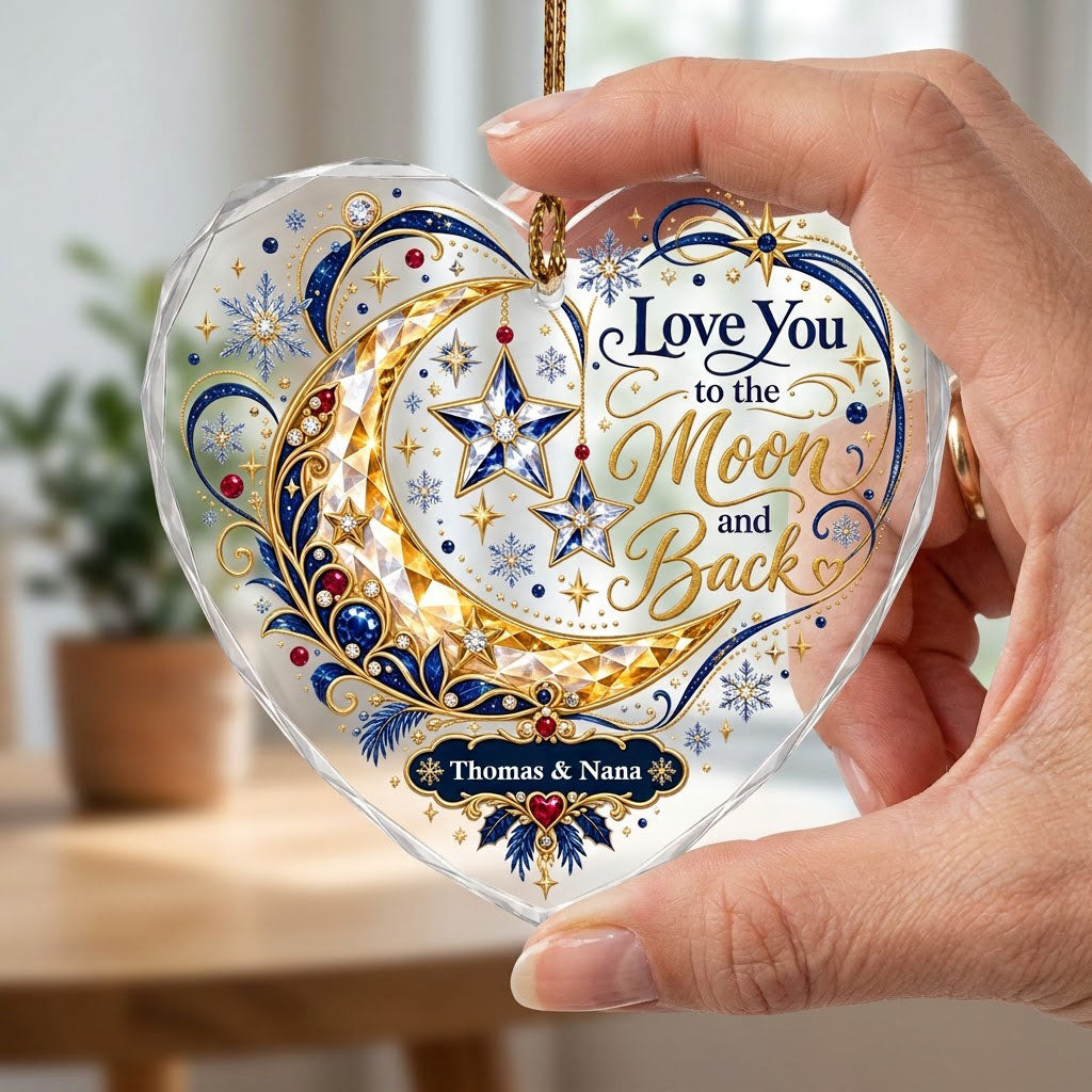Heart glass ornament with jeweled gold crescent moon, blue hanging stars, and 'Love You to the Moon and Back' text.