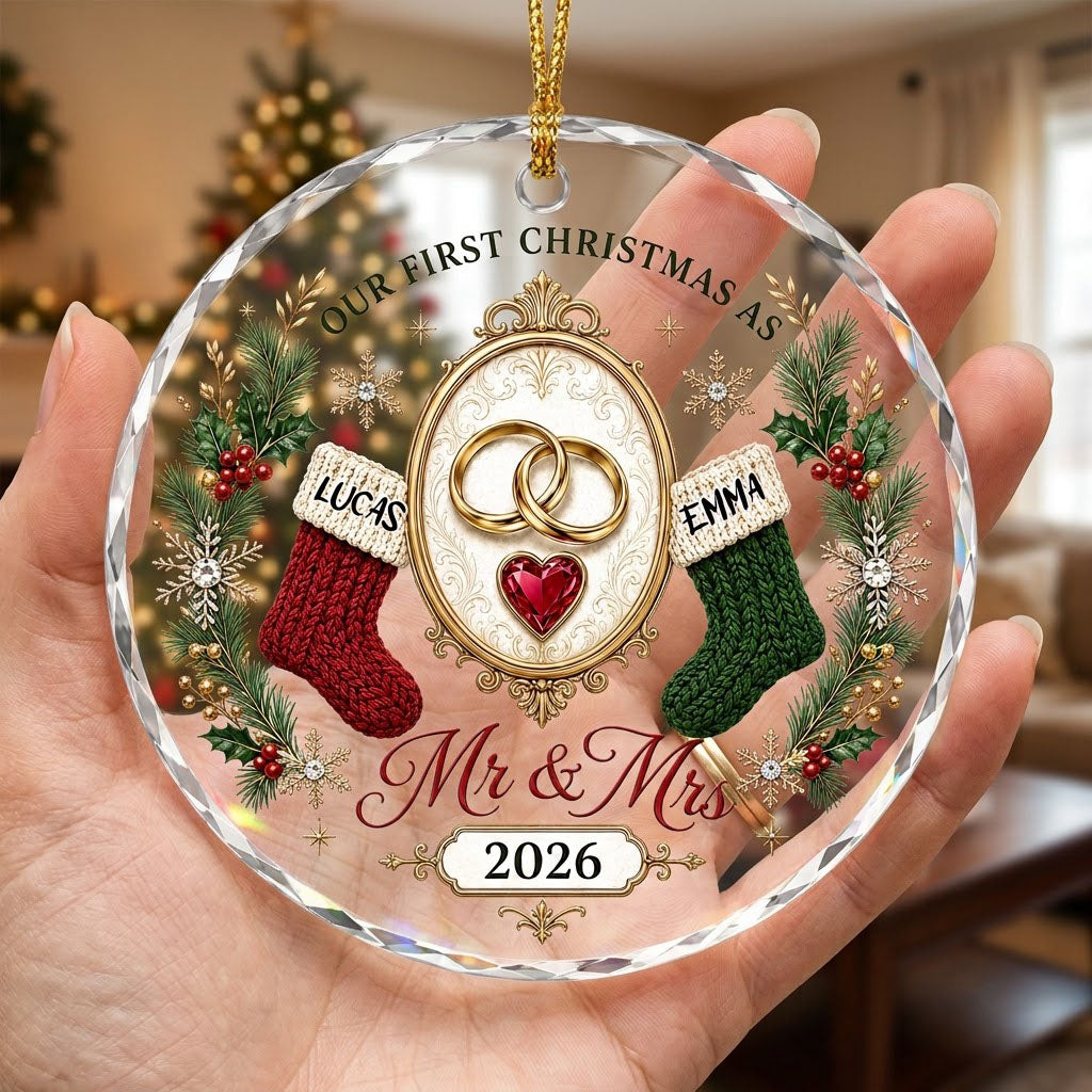 Round glass ornament with gold rings, red heart gem, red and green stockings, pine branches and Mr & Mrs text.
