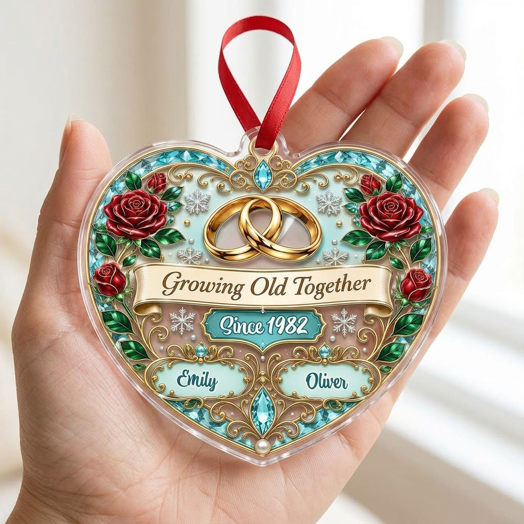Heart-shaped clear acrylic ornament with golden rings, red roses, “Growing Old Together,” and custom names with a since 