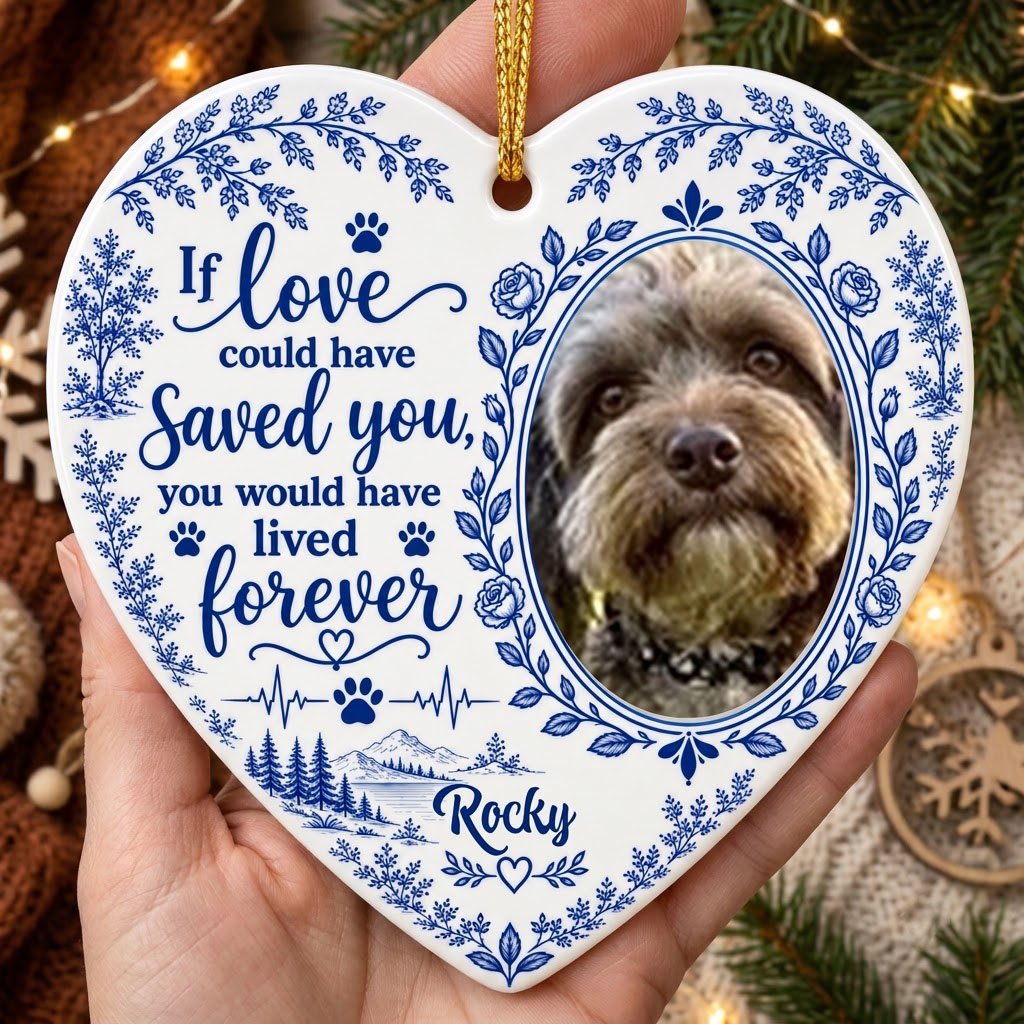 White heart ceramic ornament with blue dog photo frame wreath, memorial quote, paw heartbeat, and a mountain lake scene.