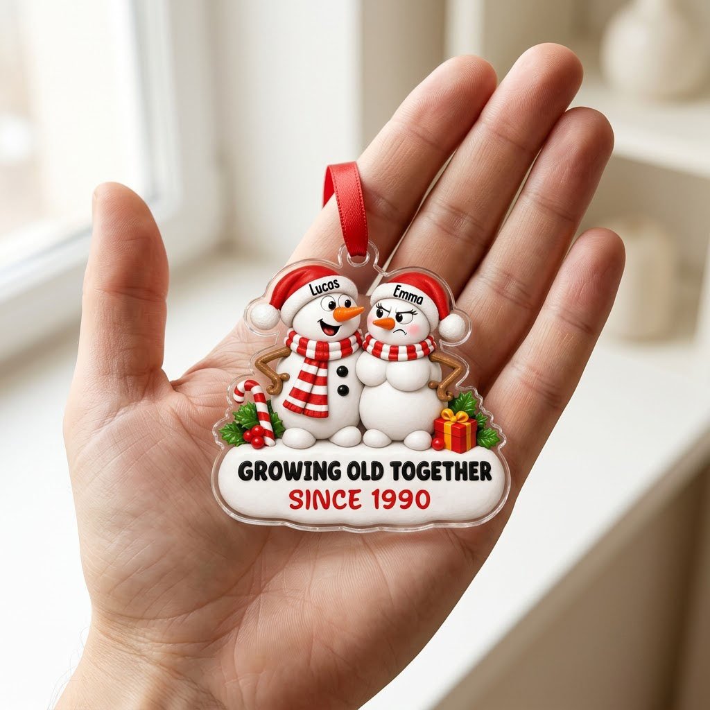 Custom-cut acrylic ornament of a snowman couple with candy cane, gift box, and Growing Old Together text on a snowy base