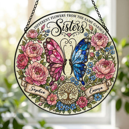Round suncatcher with pink and blue butterfly, peony wreath, Tree of Life, and Sisters text with two name ribbons.