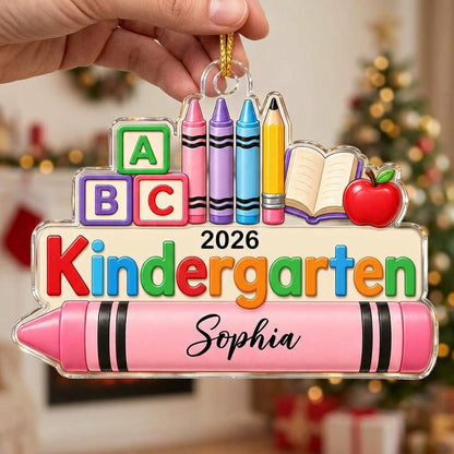 Clear acrylic ornament with ABC blocks, crayons, apple, open book and 'Kindergarten 2026' with a pink name banner