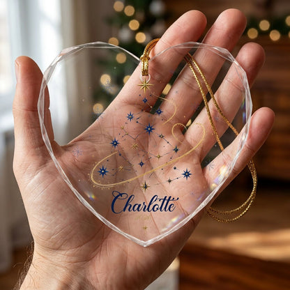 Heart-shaped stained glass suncatcher with a starry Christmas tree, gold ribbon heart, and snowflakes.