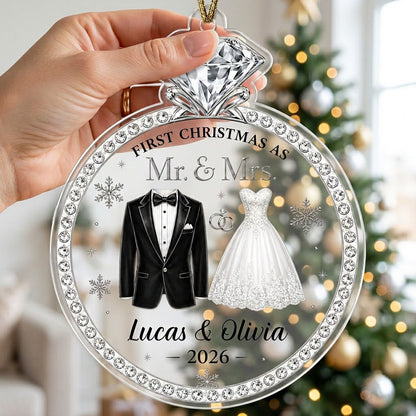 Clear acrylic diamond-ring ornament with tuxedo, lace gown, silver rings and 'First Christmas as Mr. & Mrs.' text.