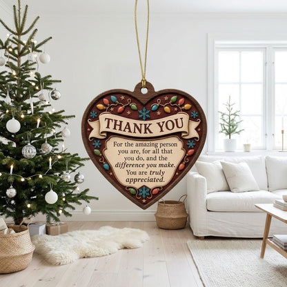 Heart-shaped wood ornament with THANK YOU message, string lights, snowflakes and stars on a burgundy background.