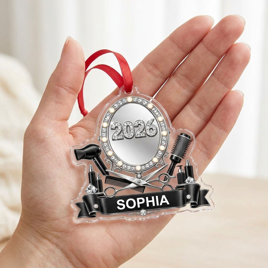 Clear acrylic ornament with a lit vanity mirror and salon tools, featuring SOPHIA and 2026 on a black banner.