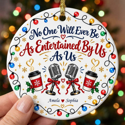 Round ceramic ornament with lights border, two microphones with red bows, and two coffee cups with heart steam.