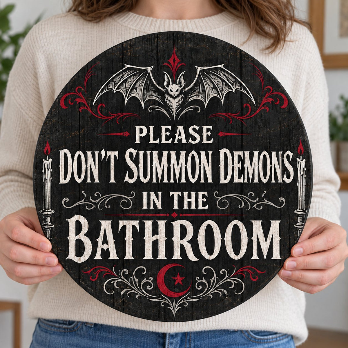 Round wooden sign with bat, filigree, candles and a crescent moon reading PLEASE DON'T SUMMON DEMONS IN THE BATHROOM.