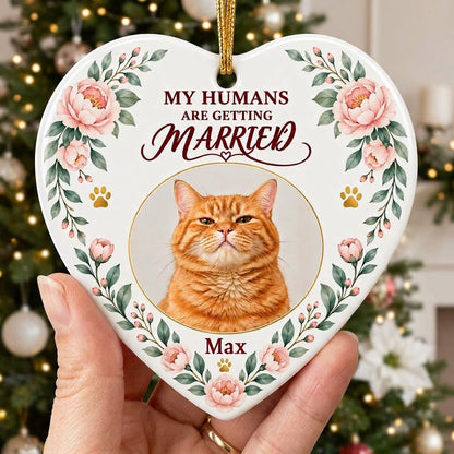 Heart ceramic ornament with 'My Humans Are Getting Married,' a cat photo, pink florals, gold paw prints, and a heart ico