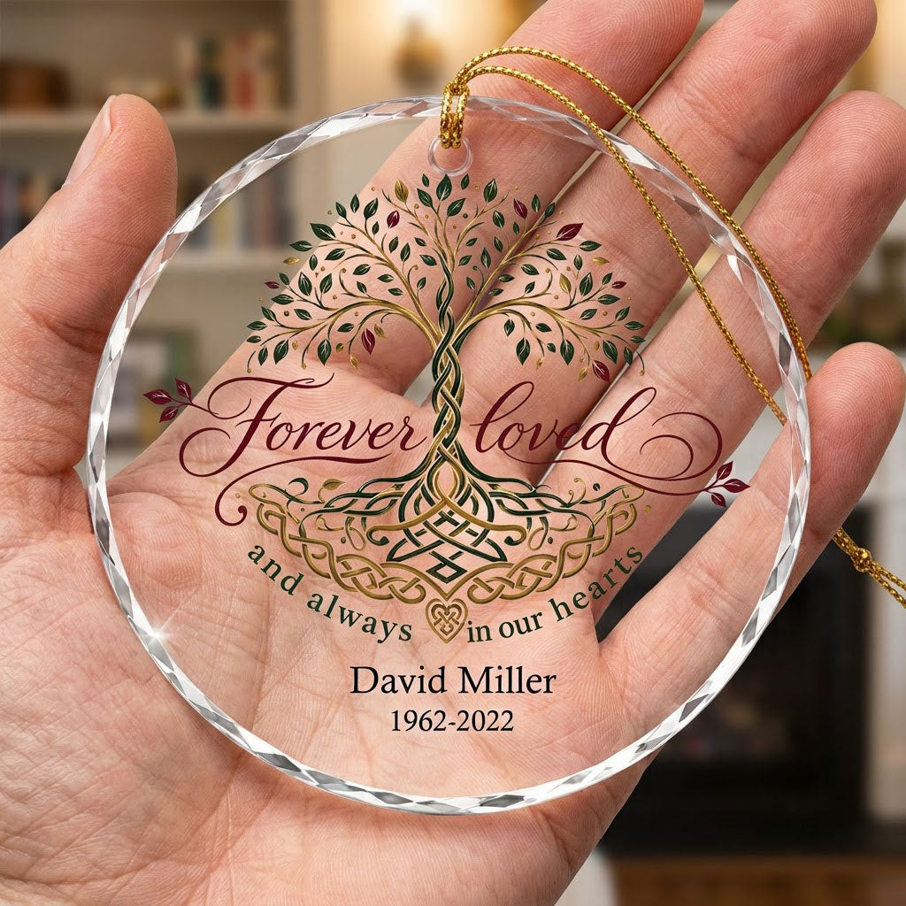 Round glass ornament with Celtic Tree of Life in green, gold and red, reading Forever loved and always in our hearts.