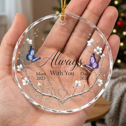 Round glass ornament with branch wreath, white blossoms, blue and purple butterflies, and Always With You text.