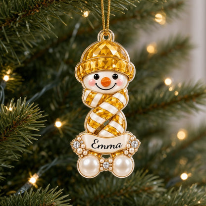 Custom-cut acrylic snowman ornament with jeweled hat and scarf, name banner, and faux pearl base.