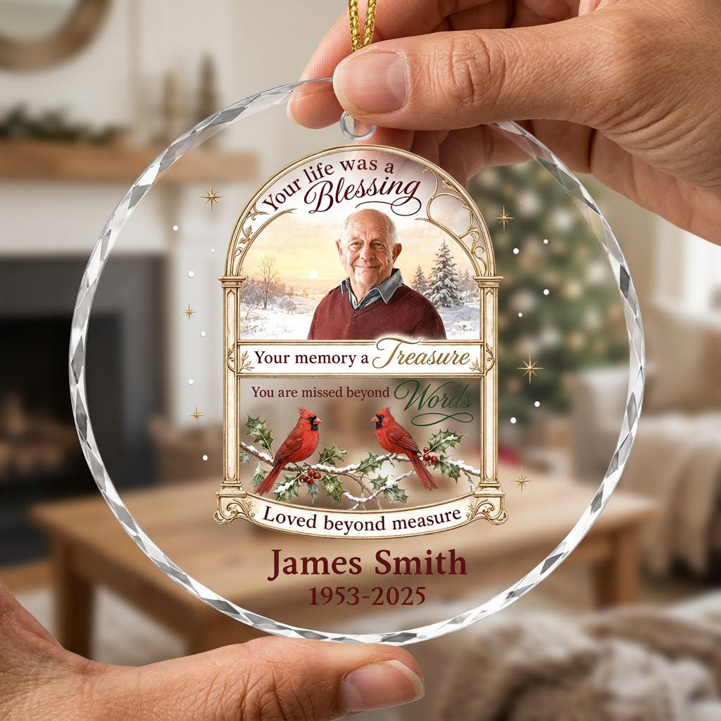 Round glass ornament with golden arched photo frame, two red cardinals on snowy pine and a memorial quote.