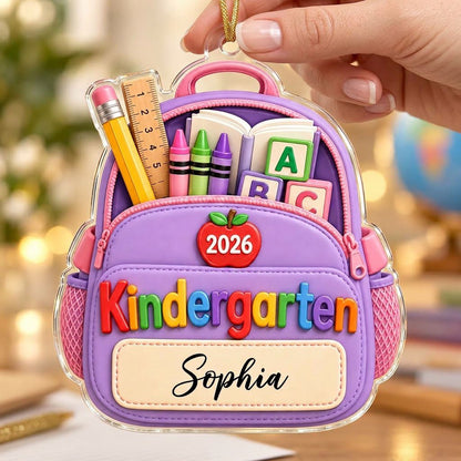 Purple backpack acrylic ornament with ABC blocks, apple, Kindergarten text, 2026 year, and a stitched name banner.