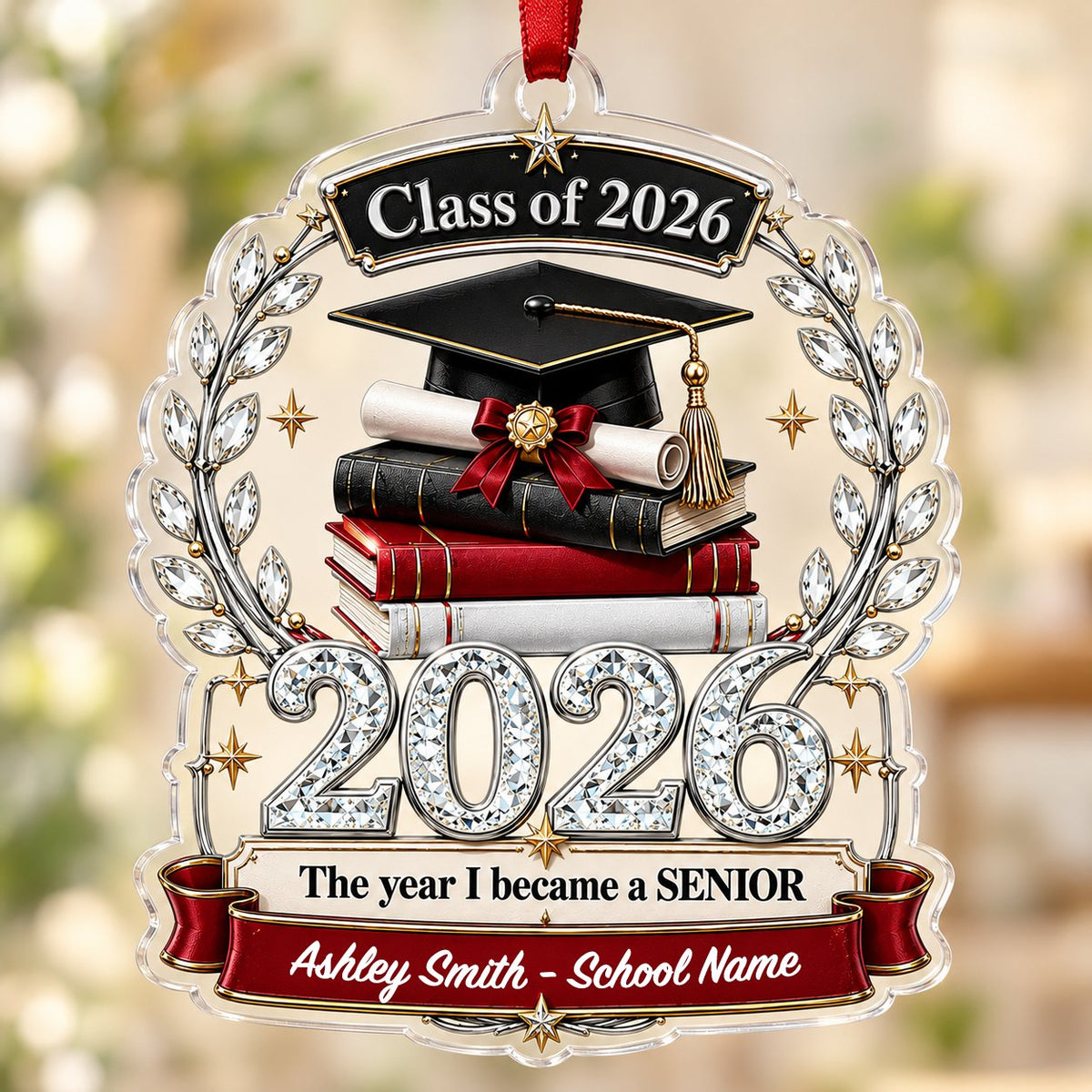 Acrylic ornament shows Class of 2026 text, cap, diploma, jeweled laurel wreath and banners personalized with name and sc
