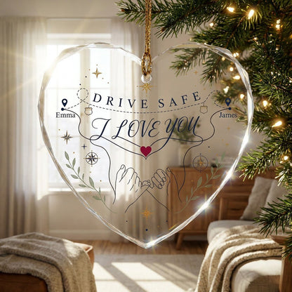 Heart glass ornament showing pinky promise hands, map pins, compass roses, green sprigs, and DRIVE SAFE and I LOVE YOU.