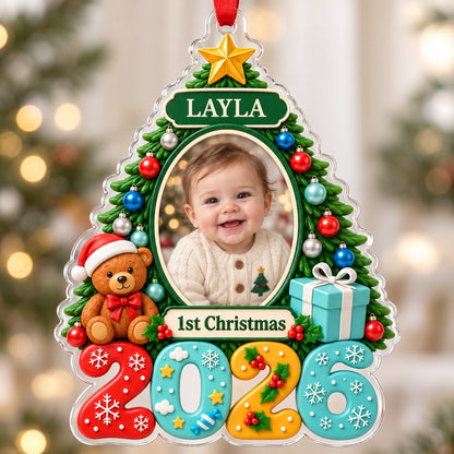 Green Christmas tree acrylic ornament with star topper, baby photo frame, teddy bear, and 2026 numbers.