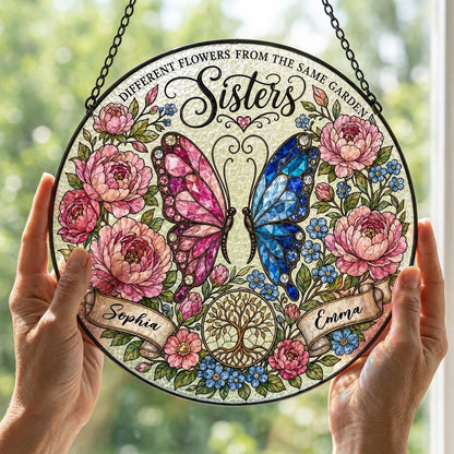 Round suncatcher with pink and blue butterfly, peony wreath, Tree of Life, and Sisters text with two name ribbons.
