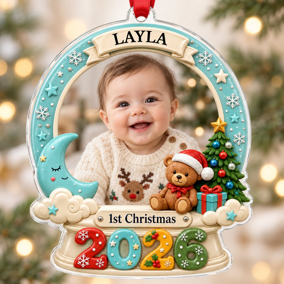 Acrylic snow-globe ornament with baby photo, "1st Christmas", teddy bear, moon, clouds, and big 2026 at the base.