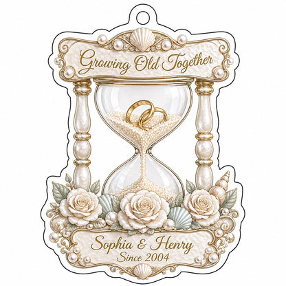 Acrylic hourglass ornament with gold rings, roses, seashells, pearls, and Growing Old Together text.