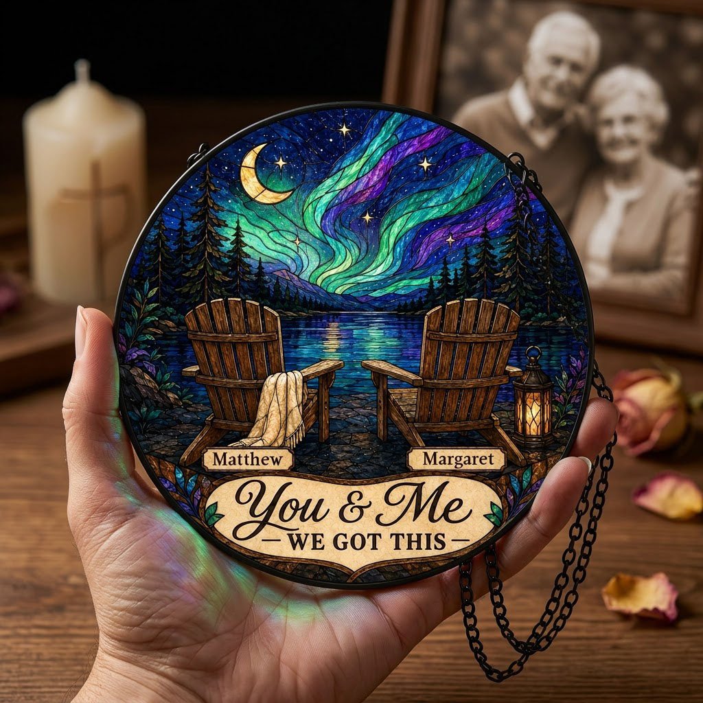 Round stained-glass style suncatcher with aurora, crescent moon, pine trees, lake, two chairs and a lantern.