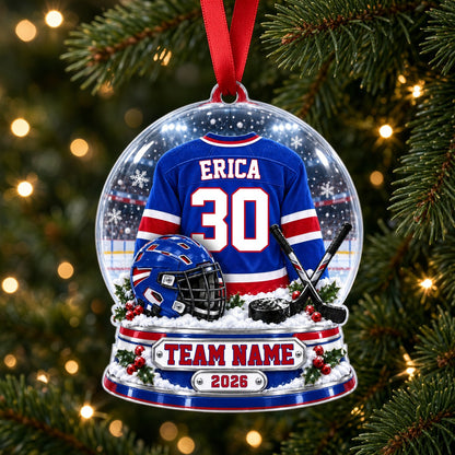 A custom-cut snow globe acrylic ornament with hockey jersey, helmet, crossed sticks, puck, and holly on the base.